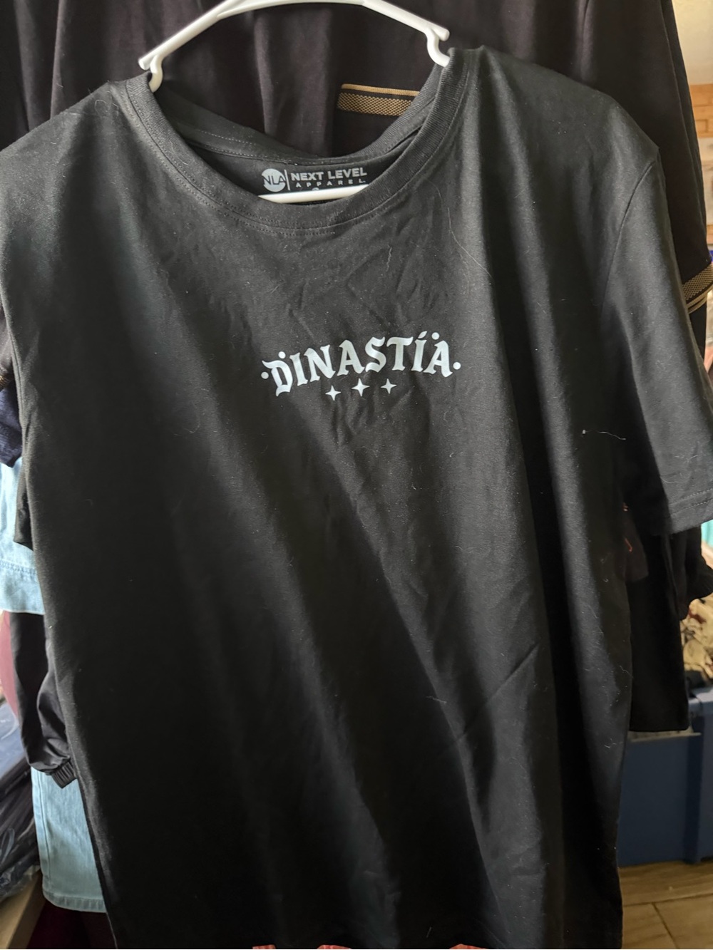 Next Level Apparel Black Tee with 'Dinastía' White Graphic